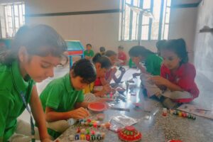 Class 3rd students making Diya